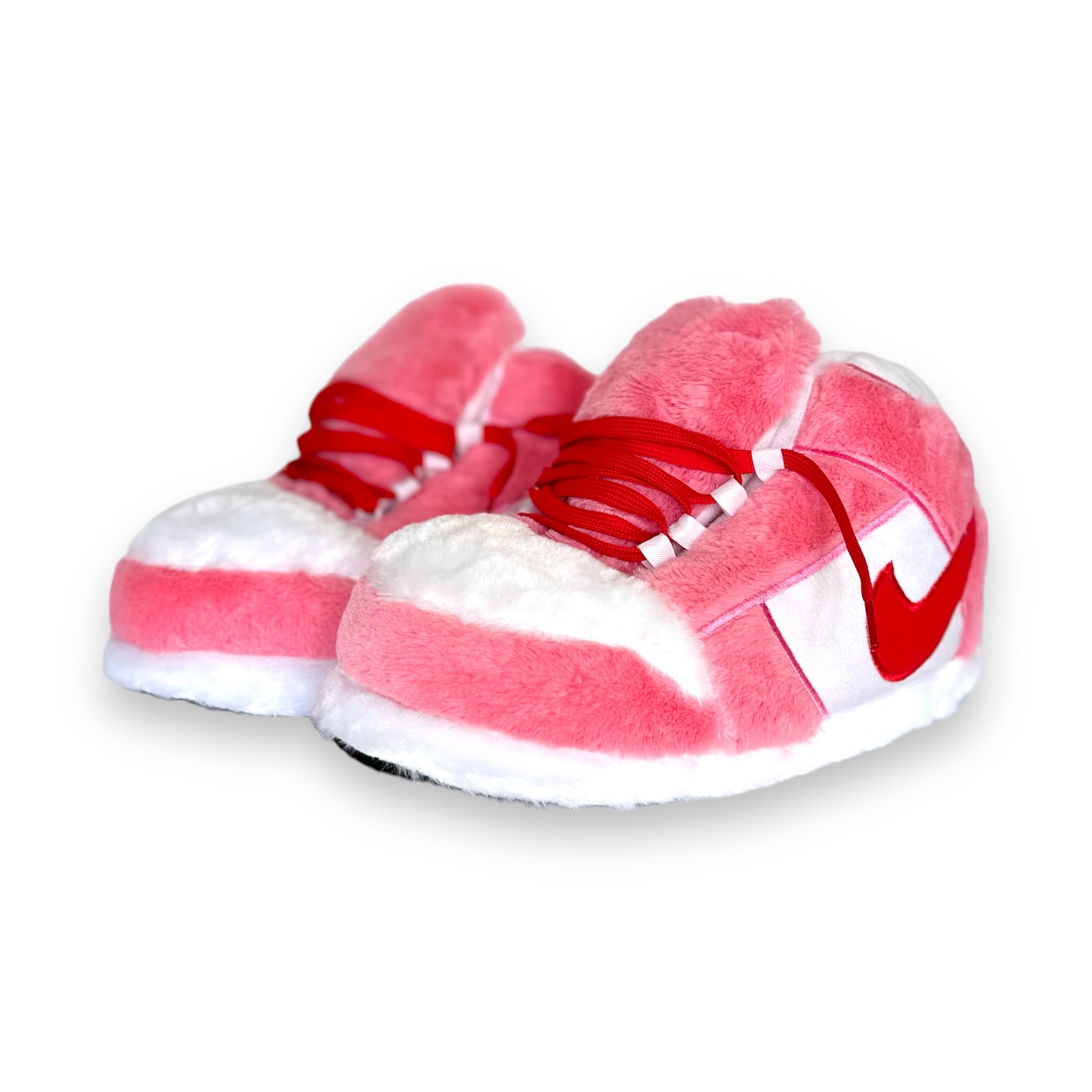 OG Pink Sneaker Slippers – plush pink and white sneaker-inspired house shoes with red accents and soft foam soles on white background.