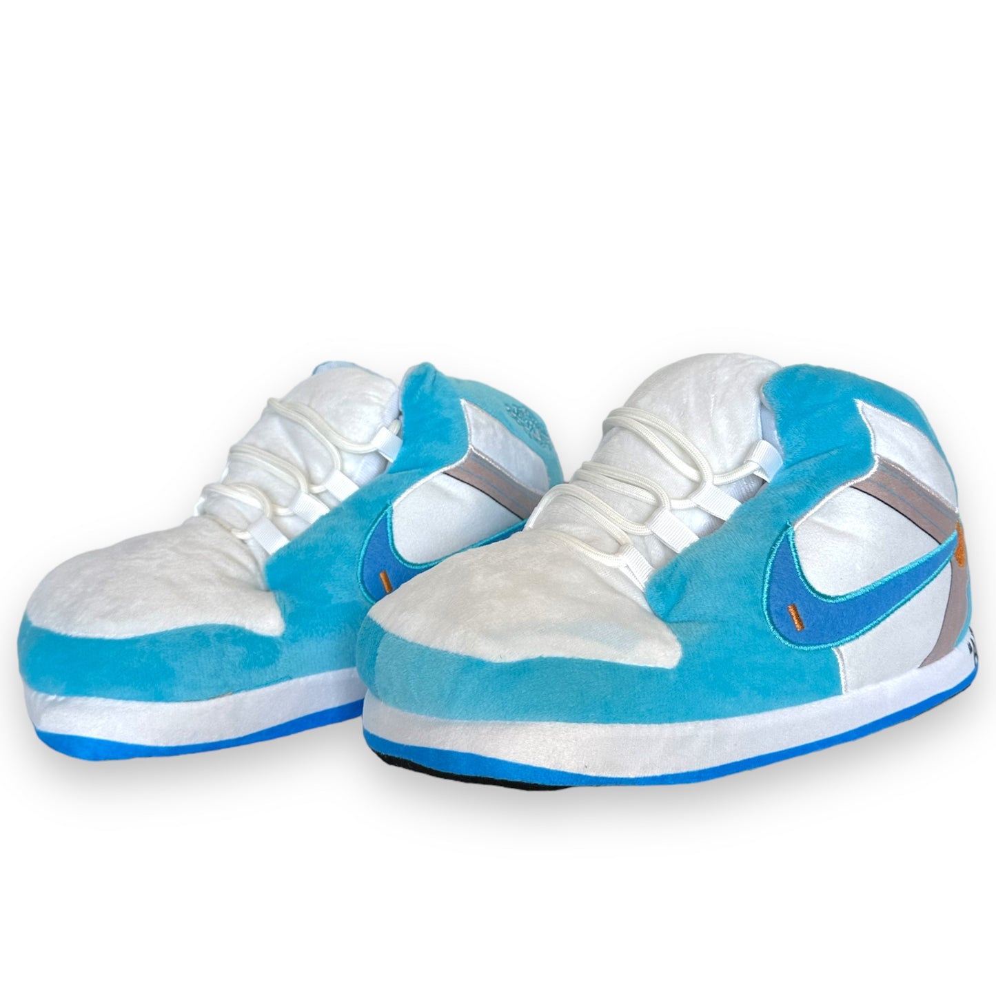 OG AIR Sneaker Slippers – plush baby-blue and white sneaker-inspired house shoes with foam soles and lace details on white background.