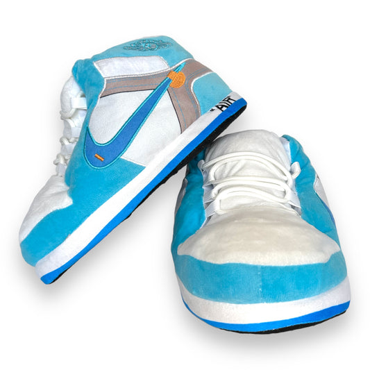 OG AIR Sneaker Slippers – plush baby-blue and white sneaker-inspired house shoes with foam soles and lace details on white background.
